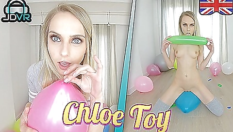 Chloe toy plays with her fingers and takes a toy in her mouth