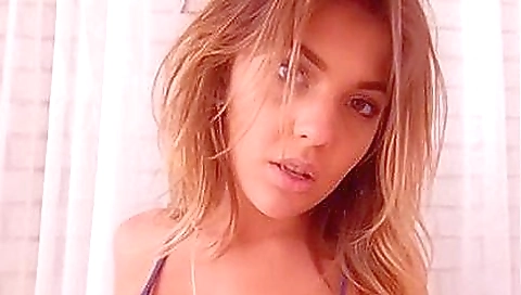 A brunette is stripping naked and stripping her face